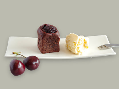 CACAOKOBO TRIBUTE カカオ工房トリビュート dark chocolate cherry brownie served with vanilla ice cream on a white plate
