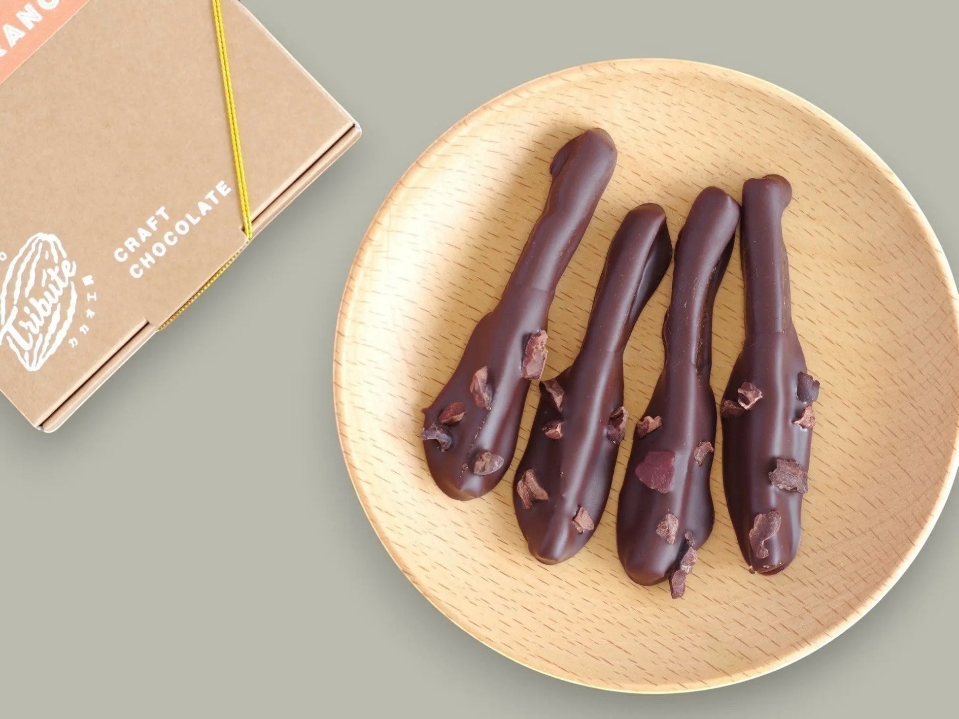 CACAOKOBO TRIBUTE ORANGETTE: dark-chocolate-covered candied orange peel with cacao nibs.