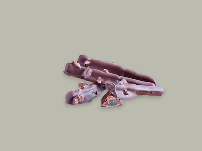 CACAOKOBO TRIBUTE ORANGETTE: Dark chocolate enrobed candied orange peel sticks topped with cacao nibs.